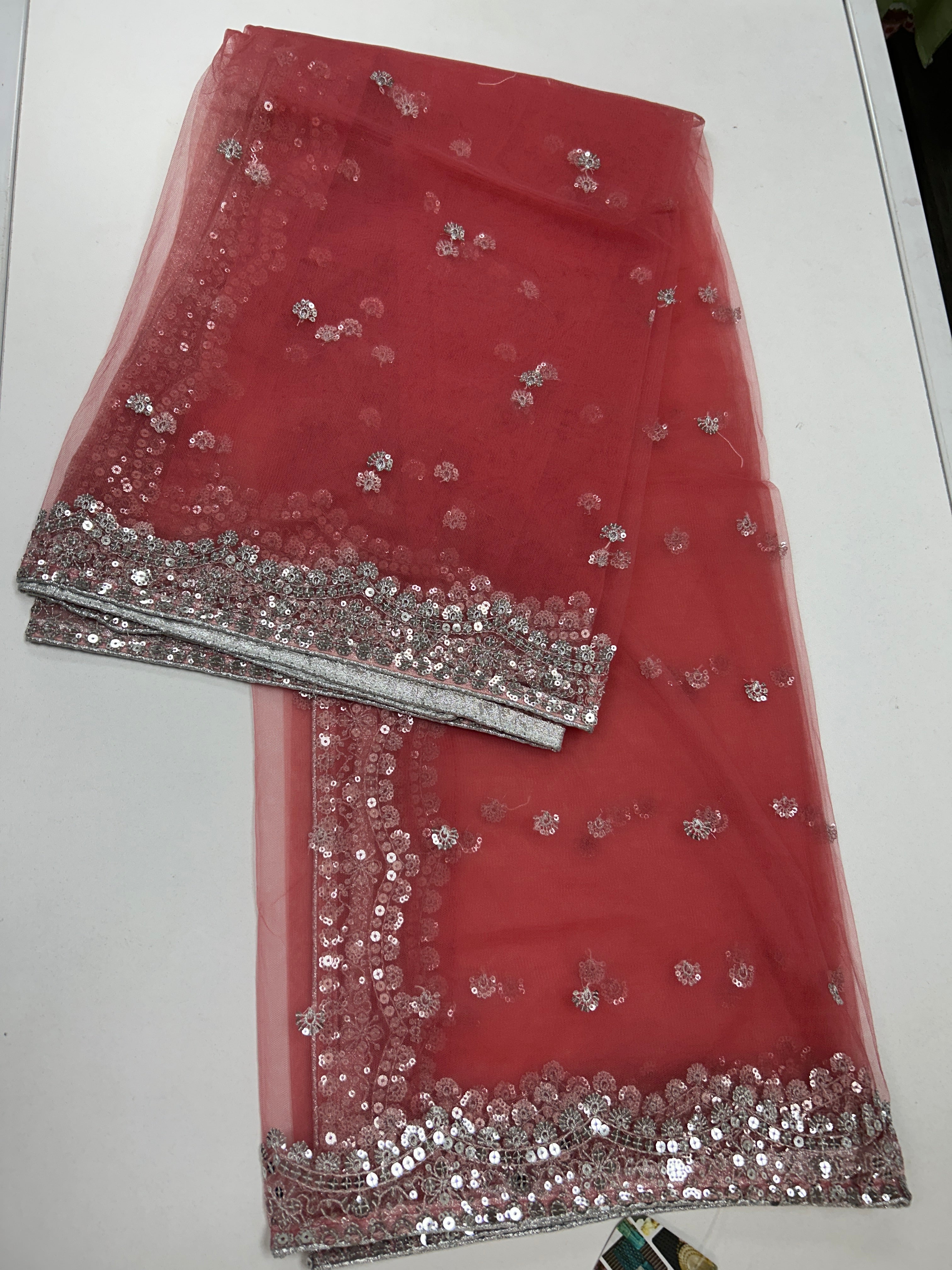 Peach pink net duppata with silver sequencework