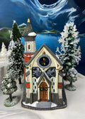 Christmas Village Church with Stained Glass Window. Illuminated House of Worship. Holiday Decor. Christmas Celebration.