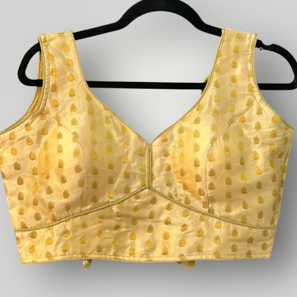 Sleeveless gold blouse
